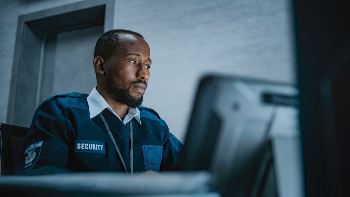 Security operator monitoring CCTV feeds during night shift
