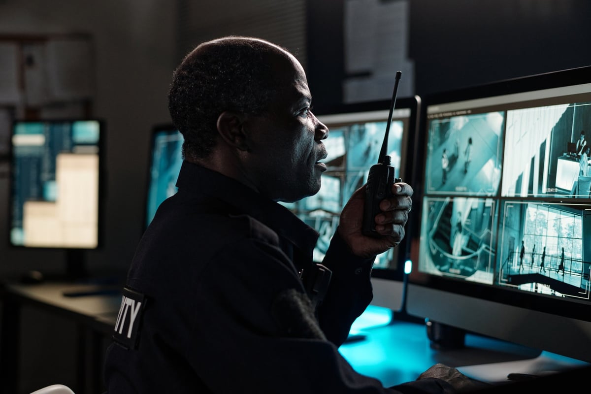 Security officer monitoring site communications and CCTV